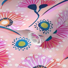 a pink flowered wallpaper with blue, yellow and orange circles on the background