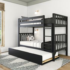 a bunk bed with a trundle underneath it in a white and black bedroom