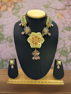 Beautiful Jaipuri meenakari purple and light green handpainted stones set embodies a detailed handpainting meenkari work along with the Kundan stones which are embedded in the lakh n alloy mixed with brass base. The teardrop doublet stones gives it a traditional look. It comes with matching earrings. The handdone piece will have imperfections which makes this one of kind.  Dimension: 8" long chain and 4.5" x 2.5" pendant size Earrings: 1.4" long  Weight: 4.2 oz and w/ packaging 7 oz Multicolor Tilla Jewelry For Gifts, Bollywood Style Multicolor Jewelry For Puja, Temple Jewelry With Meenakari As Gift, Multicolor Meenakari Kundan Necklace In Bohemian Style, Multicolor Kundan Necklace With Tilla For Gift, Multicolor Temple Necklace With Tilla As Gift, Multicolor Handmade Kundan Necklace Gift, Festive Necklaces With Motifs For Gift, Multicolor Meenakari Chandbali Necklace