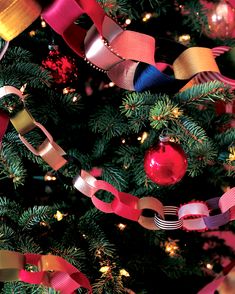 the christmas tree is decorated with ribbons and ornaments