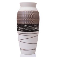 a white vase with black and brown designs on it's sides, against a white background