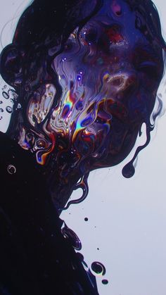 an abstract photograph of water and bubbles in blue, purple, black and white colors