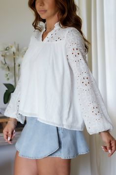 Add a touch of whimsy to your wardrobe with the Mandy Eyelet Blouse. Featuring delicate eyelet detailing, this blouse is sure to make you stand out. (Eyelet on point!) 65% Cotton 35% Polyester Color: White Long Sleeve Blouse All Over Eyelet Detail Light Weight Elastic Wrist Detail Double Lined in all the right placed Relaxed Flowy Style Ruffle Collar Detail Model is wearing a size Small. She is 5'6". 130lbs. Bust: 34" Waist 26" Hips 36" Chic Cotton Blouse With Cutwork Hem, Long Sleeve Blouse For Daywear With Cutwork Hem, Chic Long Sleeve Tops With Cutwork Hem, Spring Daywear Blouse With Cutwork Hem, Long Sleeve Summer Tops With Cutwork Hem, Summer Long Sleeve Tops With Cutwork Hem, Spring Casual Blouse With Cutwork Hem, Fitted Blouse With Cutwork Hem For Spring, Elegant Tops With Cutwork Hem For Spring