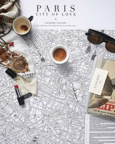 a map with sunglasses, coffee and other items on it