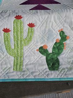 Southwest themed table runner. Make this stunning quilt block with cactus applique the center of your table decor. Finishes 16" x 42". Advanced beginner. Cactus Applique Pattern, Cactus Quilt Pattern, Desert Quilt, Cactus Applique, Table Runner Quilt Pattern, Table Runner Quilt, Quilted Table Runners Patterns, Table Quilts, Baby Quilt Patterns