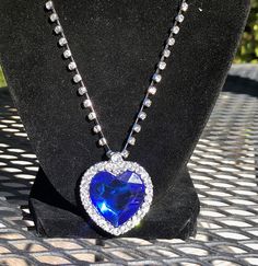 The famous blue heart of the ocean necklace. Beautiful sparkle, created gemstones are  properly faceted to capture and reflect the light.  measures 20 inches plus a 2 inch extender is included. Blue Jewelry For Valentine's Day Party, Blue Heart Pendant Jewelry For Party, Heart Cut Crystal Necklace For Party, Blue Heart Cut Jewelry For Gift, Heart-shaped Crystal Jewelry With Jewels, Sapphire Heart Pendant With Heart Charm, Blue Round Pendant Necklace For Party, Blue Heart Pendant Necklace For Valentine's Day, Blue Crystal Necklaces For Gifts