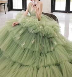 Step into a world of elegance and sophistication with our Sage Green Tiered Tulle Gown. This exquisite ball gown features a stunning tiered tulle skirt that creates a dramatic and voluminous silhouette, perfect for making a grand entrance. The corset back adds a touch of timeless charm while ensuring a perfect fit. The gown's sage green hue exudes a sense of tranquility and grace, making it an ideal choice for any formal occasion. Delicate embellishments and intricate detailing enhance the gown' Evening Dress Plus Size, Simple Satin Wedding Dress, Prom Dress Green, Nontraditional Wedding Dress, Tulle Long Prom Dress, Tiered Tulle Skirt, Fairy Wedding Dress, Sweet 16 Dress, Gothic Wedding Dress