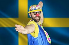 A cheerful clown stands in a welcoming pose against the background of the flag of Sweden stock image Sweden, Flag