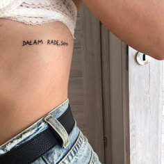 a woman's stomach with the words dream, rad, aim written on it