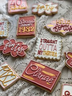 some cookies that are on a doily with the names of different people and numbers