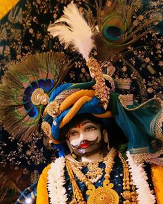 a man dressed in an elaborate costume with feathers on his head