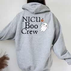 "NICU CNA Halloween, Matching Staff Shirts, CNA Ghost Sweatshirts, NICU CNA Sweater, NICU CNA Fall Shirts, CNA Appreciation, CNA Gift. How adorable are these hoodies? Print on front and back. Back says \"NICU Boo Crew\" with a cute ghost. The front left chest has the same ghost with professional title. *Please see my shop under \"Professions\" to find other matching crew sweatshirts with different titles: Nurse, CNA, Respiratory, Doctor and Unit Clerk.* Peds also has therapy So far we have matching sweatshirts for NICU, PICU and Peds. Made with a thick blend of cotton and polyester, it feels plush, soft and warm, a perfect choice for any cold day. Message me for orders of 15+ for a discount. In the front, the spacious kangaroo pocket adds daily practicality while the hood's drawstring is t Nicu Halloween, Cna Appreciation, Staff Shirts, Nicu Nursing, Doctor Halloween, Hoodies Print, Halloween Matching, Respiratory Therapist, Boo Crew