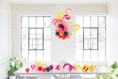 the table is decorated with balloons and streamers for an elegant look to it's dining room