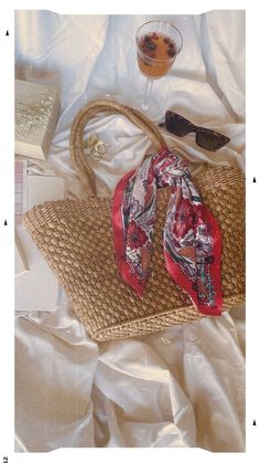 Floral botanical print satin scarf tied to a straw tote bag pictured as a flatlay with sunglasses and a cocktail over a cream picnic blanket sheet Scarf On Bag, Satin Neck Scarf, Bougie Outfits, Scarf Aesthetic, Outfit Style Ideas, Scarf Trends, Satin Scarf, Silk Bag, Chanel Collection