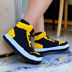 Handcrafted Yellow & Black Crochet Sneaker Slippers - Unisex Jordan-Inspired Cozy Plush Home Shoes - Stylish Non-Slip Knit Basketball Slippers - Unique Artisanal Sneaker-Style Booties - Comfy Collectible Loungewear Footwear - Perfect Gift for Sneakerheads Experience the ultimate blend of sports legacy and homestyle comfort with our Handmade Sneaker Slippers, a premium addition to any loungewear collection. Drawing inspiration from the basketball courts, our Jordan-Inspired Home Shoes capture the spirit of the game in a vibrant yellow and black color scheme. Each pair of our Yellow Black Crochet Slippers is a masterpiece of craftsmanship, meticulously woven to offer a unique sneaker style slipper that stands out from the crowd. Designed for fans, fashionistas, and comfort-seekers alike, the Comfy Crochet, Yellow Slippers, Collection Drawing, Jordan Style, Knit Slippers, Basketball Courts, Black Jordans, Unique Sneakers, Shoes Jordan