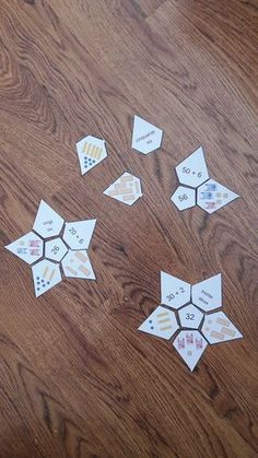 several pieces of paper cut out to look like hexagons on a wooden table