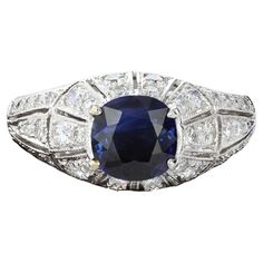 Understated elegance in an exceptional package. This charming ring is centered with a cushion cut sapphire that weighs approximately 0.90ct and has 44 round cut diamonds that weigh approximately 0.50ct. The setting has a raised dome effect with milgrain beading. The color of these diamonds is H with VS clarity. The ring weighs 4 grams. Size 7 Sapphire And Diamond Ring, Ring Art Deco, Detailed Ring, Sapphire Diamond Ring, Dream Jewelry, Sapphire Diamond, Ring Ring, Round Cut Diamond, Cushion Cut