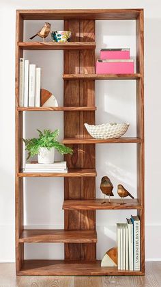 a wooden shelf with books and plants on it