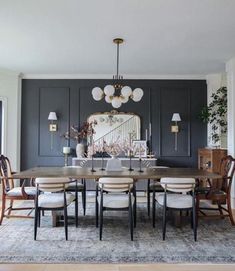 a dining room table with chairs and a chandelier