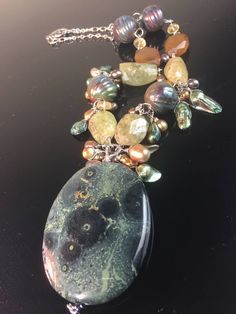 Large focal dendrite opal pendant with a hand wired chain filled with garnet, pearls and 2 raku pottery beads. Elegant Freeform Natural Stones Necklace, Bohemian Pearl Pendant Necklace With Natural Stones, Elegant Moss Agate Gemstone Beads Jewelry, Elegant Jasper Beaded Necklace For Gift, Unique Moss Agate Jewelry With Natural Stones, Unique Ocean Jasper Jewelry With Natural Stones, Handmade Jasper Elegant Necklace, Handmade Ocean Jasper Nature-inspired Necklace, Elegant Handmade Jasper Necklaces