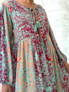 "This is beautiful light silky tunic dress with floral print in delicate blue and pink colours true boho chic style it is made loose and flared with high waist and long puff sleeve effortles to wear and easy fitting to all shapes perfect outfit for many occasions parties dinners birthday Christmas 😊 MEAESURE size M/L shoulders 18\" bust up to 40\" ( it is front tie srap, so can be easyli loosen up or tighten ) high waist 38\" length 45 \" MATERIAL *polisilk Thank You for looking" Casual Boho Maxi Dress With Tassels, Spring Floral Print Billowy Dress, Spring Bohemian Chiffon Midi Dress, Spring Bohemian Chiffon Dress, Bohemian Chiffon Spring Dress, Green Viscose Dress For Fall, Casual Billowy Dress With Bishop Sleeves, Spring Multicolor Kaftan With Tassels, Bohemian Multicolor Fall Dresses