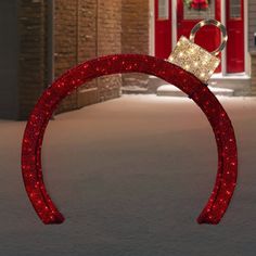 a pair of red glittered headbands with a gold crown on it in front of a brick building