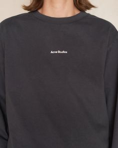 Logo longsleeve T-shirt by Acne Studios in black. Relaxed fit crewneck tee crafted from midweight cotton jersey. A wardrobe essential featuring the iconic logo stamped on the center front, adding a touch of contemporary chic. 100% Cotton.Made in Portugal.