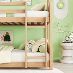 there is a bunk bed in the room with green walls and pictures on the wall