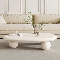 a white coffee table sitting on top of a carpeted floor next to a couch