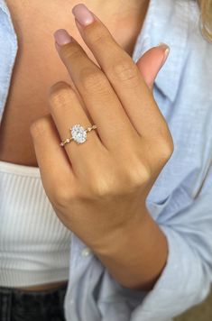 a woman's hand with a diamond ring on it