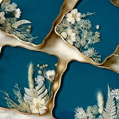 four blue plates with flowers and leaves on them