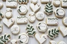 decorated cookies with wedding date and names on them are laid out for the guests to eat