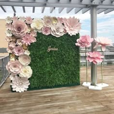 an outdoor area with artificial flowers and greenery