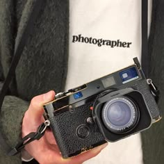 a person holding an old camera in their hand