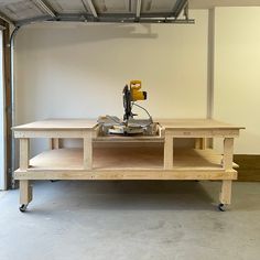 a table with a sewing machine on it in a room that is being worked on