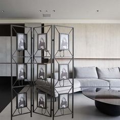 a room divider in the middle of a living room with couches and tables