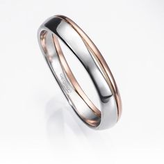 two tone gold and silver wedding ring on a white background with the word love written in it