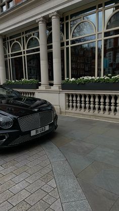 a black car parked in front of a building