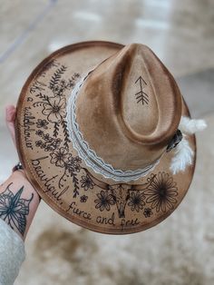 This is a tan suede hat with flowers, words, and a longhorn skull burned in.  Comes with everything you see on the hat as well.  This hat is adjustable and fits MOST head sizes.  Keep in mind each hat is free hand burned so can differ slightly. Lainey Wilson Hats, Cute Country Pictures, Hat Burning Ideas, Western Hats For Women, Burnt Hats, Burned Hats, Hat Burning, Custom Cowboy Hats, Lainey Wilson