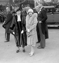 an old black and white photo of people on the street