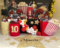 a table with popcorn and balloons on it