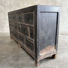 an old wooden dresser with many drawers on one side and two doors on the other