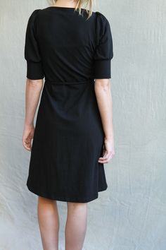 "This Folded Dress is made from a soft cotton jersey. It has an envelope neckline, puff sleeves, and folded topstitching at the front. The folded detail is done by hand, making each dress one of a kind. There are ties attached at the sides that can be wrapped and tied at the front or back. Pair this dress with a great pair of boots or heels. S I Z I N G The measurements below are your measurements. Bust- around full bust (not bra size) Waist- smallest part of waist. Hips- fullest part of hips, a Modest Fitted Puff Sleeve Dress, Fitted Cotton Dress With Gathered Waist, Cotton Fitted Dress With Gathered Waist, Fitted Dresses With Puff Sleeves And Gathered Waist, Modest Fitted Puff Sleeve Dress With Short Sleeves, Modest Puff Sleeve Dress With Gathered Sleeves, Fitted Cotton Puff Sleeve Midi Dress, Fall Daywear Fitted Puff Sleeve Dress, Fitted Cotton Puff Sleeve Dress For Work