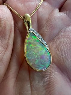 "This striking pendant is crafted in solid 18k gold and features a fabulous Australian crystal opal adorned with diamonds. *Includes* solid gold 18k chain (or I can revise the price if you only want the pendant)  price can be lower depending on payment method.  details to follow... **You can pay in instalments (layaway **Returns accepted** **Buy with confidence - see my reviews** **Offers welcome** **Fast and free shipping** Certification - I can arrange an independent insurance valuation from a high street jeweller at cost (usually £10- 20)  Pictures form the main part of the description, please email if you have questions before purchasing and I'll be happy to try and help. Any box shown not included unless stated, all items sent in vintage, antique or new gift box. *Instagram/Video/Pict Diamond Cabochon Pendant Necklace, Elegant Ethiopian Opal Pendant Necklace, Elegant Ethiopian Opal Cabochon Necklaces, Elegant Opal Necklace With Large Pendant, Gold Diamond Necklace With Cabochon, Elegant Ethiopian Opal Necklace In Yellow Gold, Luxury Opal Necklace With 17 Jewels, Elegant Opal Jewelry With Large Pendant, Formal Opal Necklace With 17 Jewels