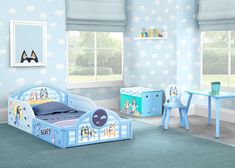 a child's bedroom with blue walls and furniture