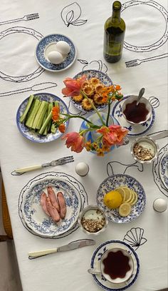 a table topped with plates and bowls filled with food