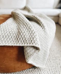 a white blanket on top of a wooden table