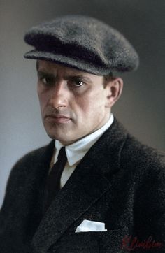 an old photo of a man in a suit and hat