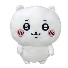 a white stuffed animal with black eyes and pink cheeks, sitting on a white surface