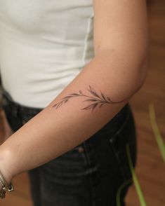 a woman with a small tattoo on her arm